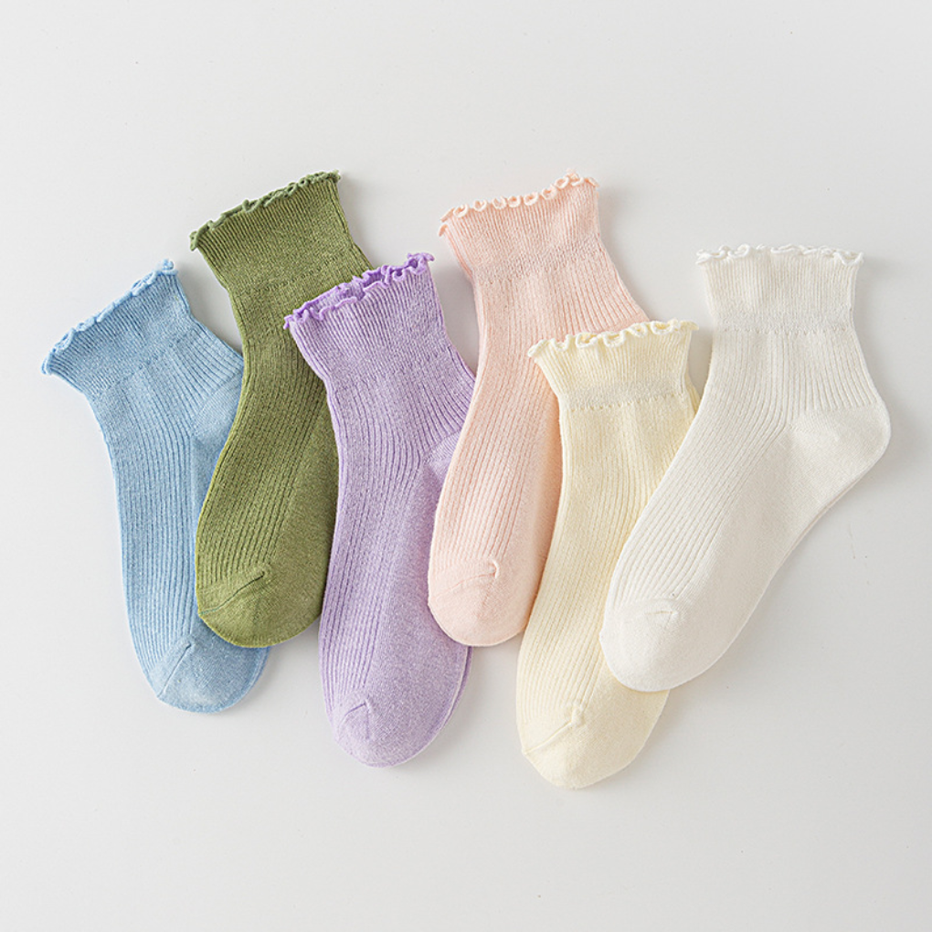 Women's white ruffled trim ankle socks. Cute frilly low-cut ladies' fashion socks, perfect for everyday wear.