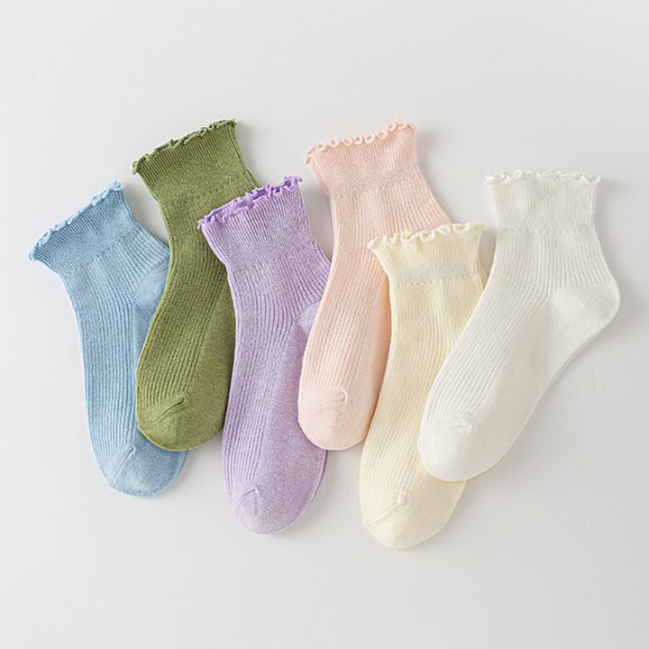 Women's white ruffled trim ankle socks. Cute frilly low-cut ladies' fashion socks, perfect for everyday wear.