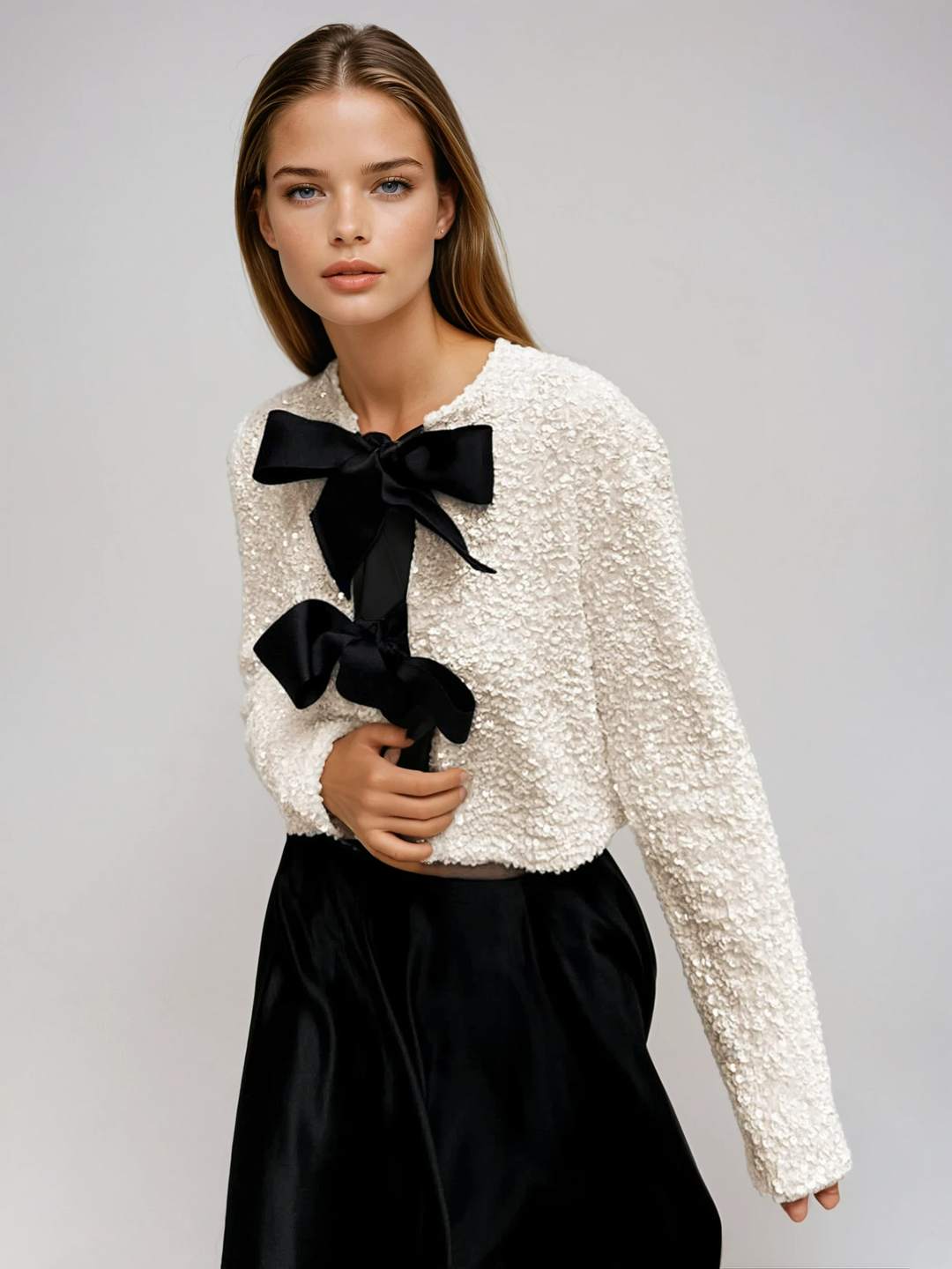 Women's shimmering beige sequin jacket with elegant bow detail, perfect for evening wear & parties.