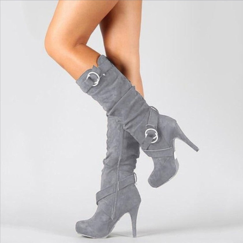 Women's sleek stiletto knee-high boots with bold ring buckle straps, perfect for fashion, party, or evening wear.
