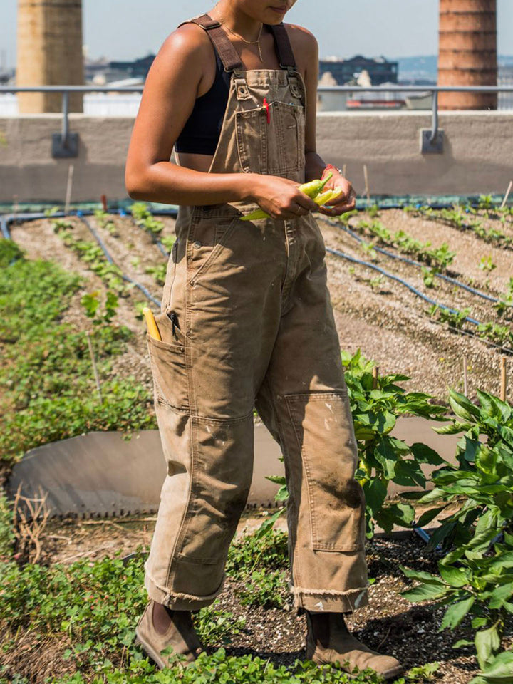 Women's sleeveless utility jumpsuit in a stylish dungaree design.