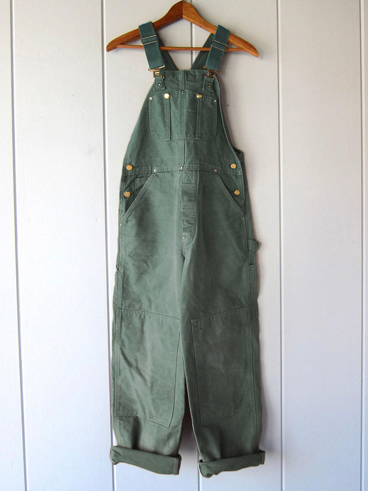 Sleeveless women's jumpsuit featuring a classic dungaree silhouette.