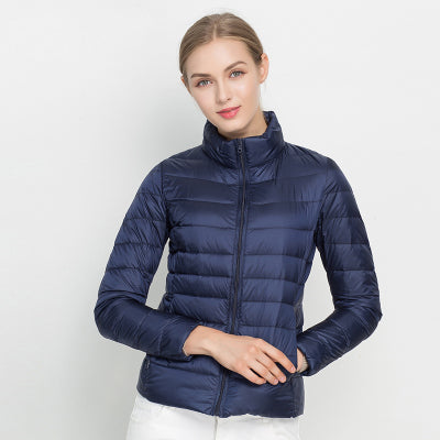 Warm women's slim fit quilted puffer jacket. Stylish zip-up outerwear with stand collar for winter.
