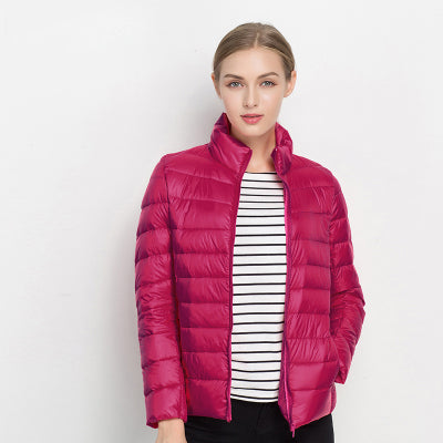 Quilted slim fit women's puffer jacket with stand collar. A warm, zip-up winter coat for women.