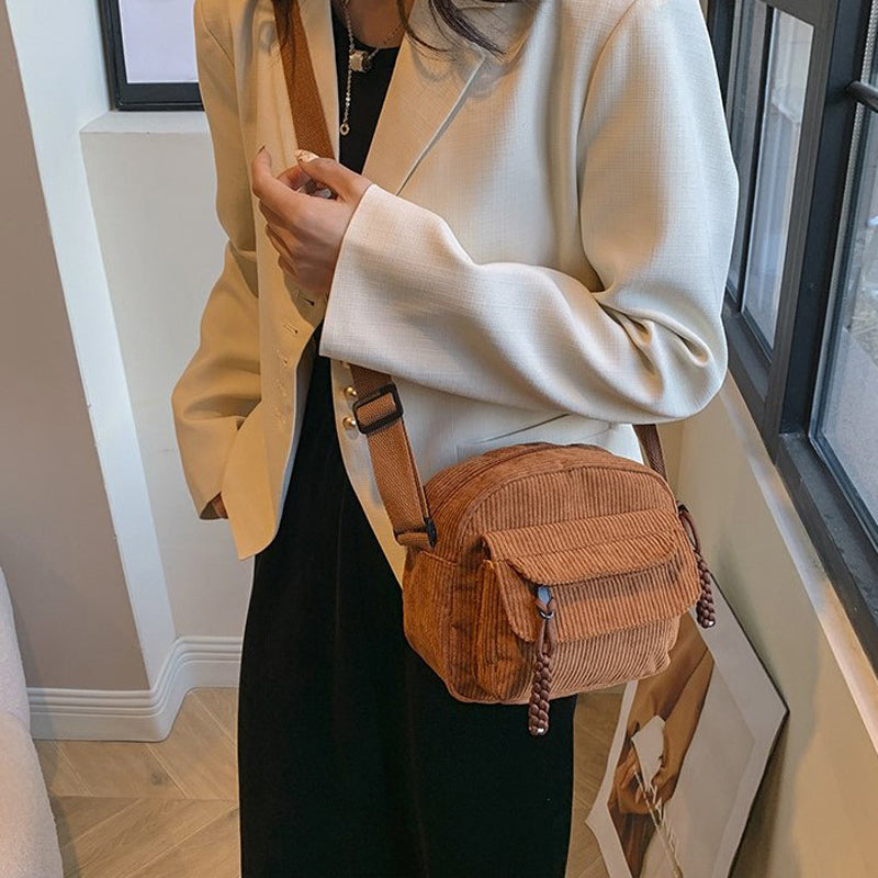 Functional small crossbody bag with a secure zip pocket for women's fashion.