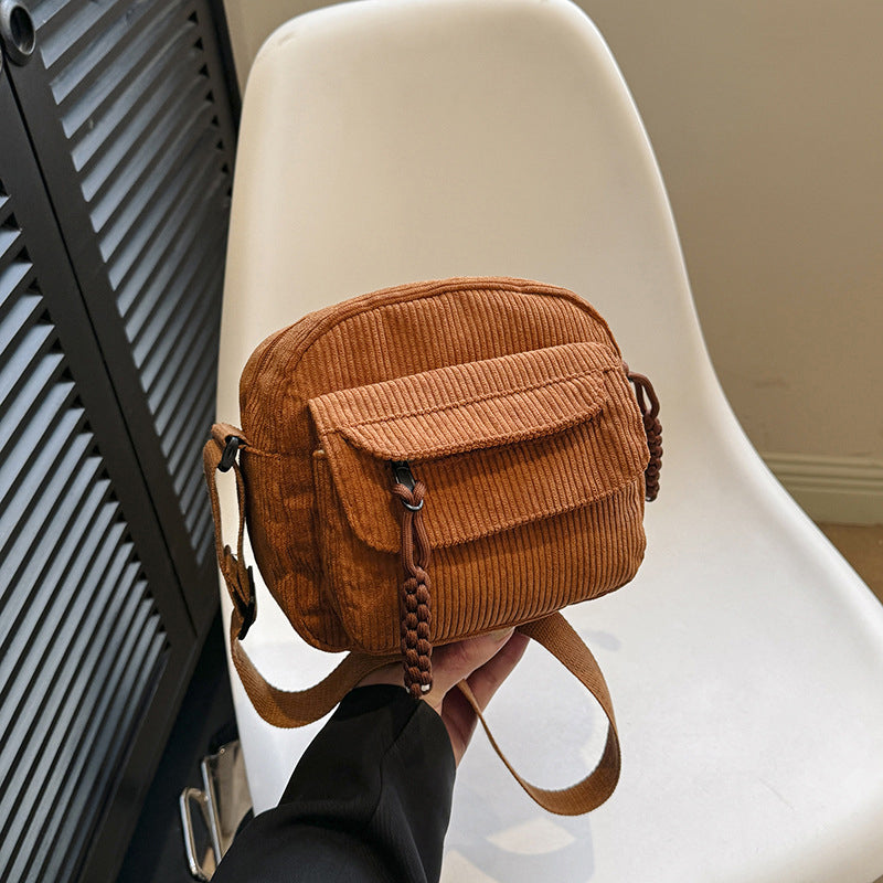 Stylish vintage-style crossbody bag for women featuring a secure zip pocket.