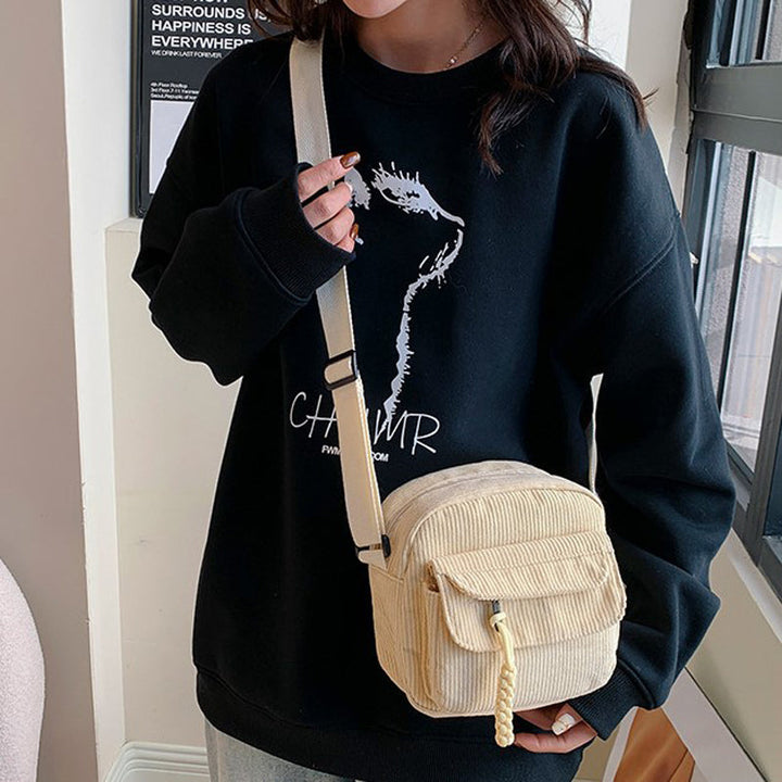 Compact women's crossbody bag with a secure zip pocket, perfect for on-the-go.