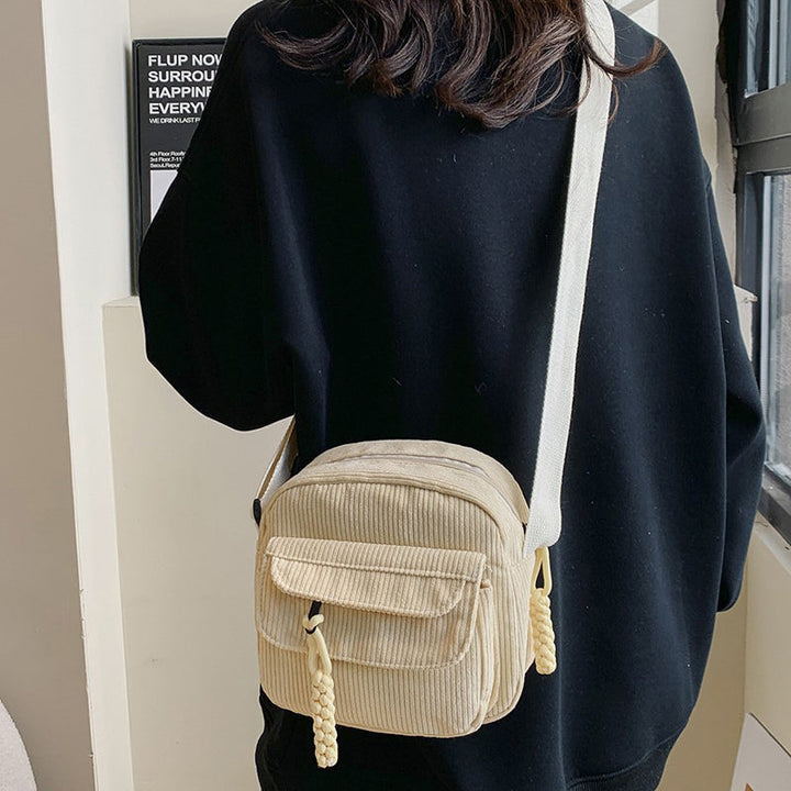 Women's accessory: textured small crossbody bag with a zip pocket.
