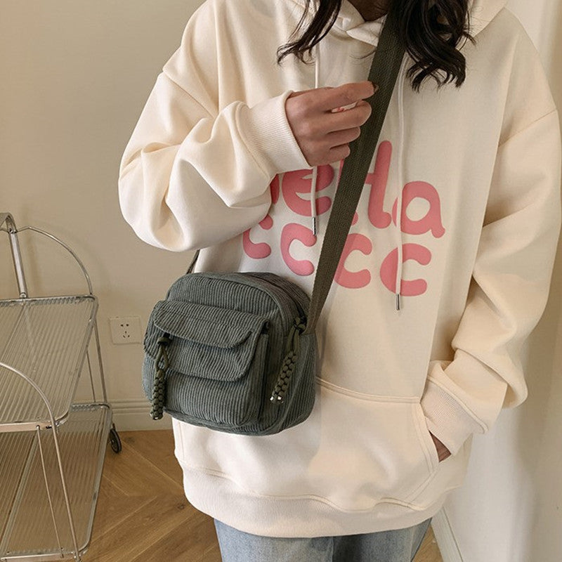 Textured fashion bag for women, a stylish crossbody with a zip pocket.