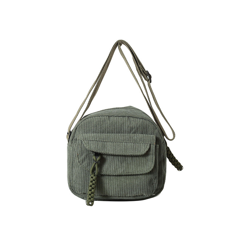 Elegant women's crossbody bag, textured with a secure zip compartment.