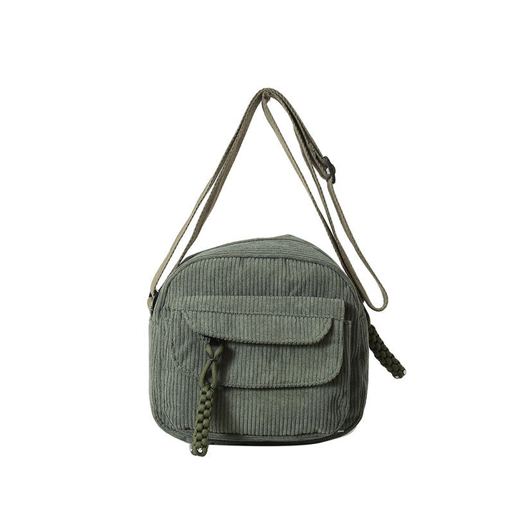 Elegant women's crossbody bag, textured with a secure zip compartment.