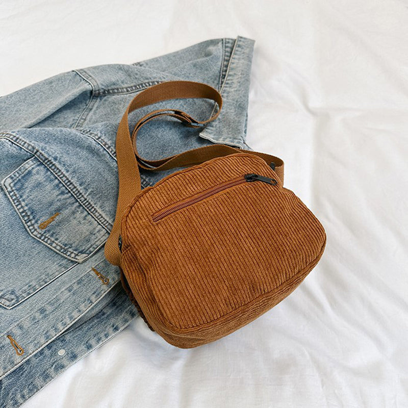 Elegant small crossbody bag with a convenient zip closure for women.