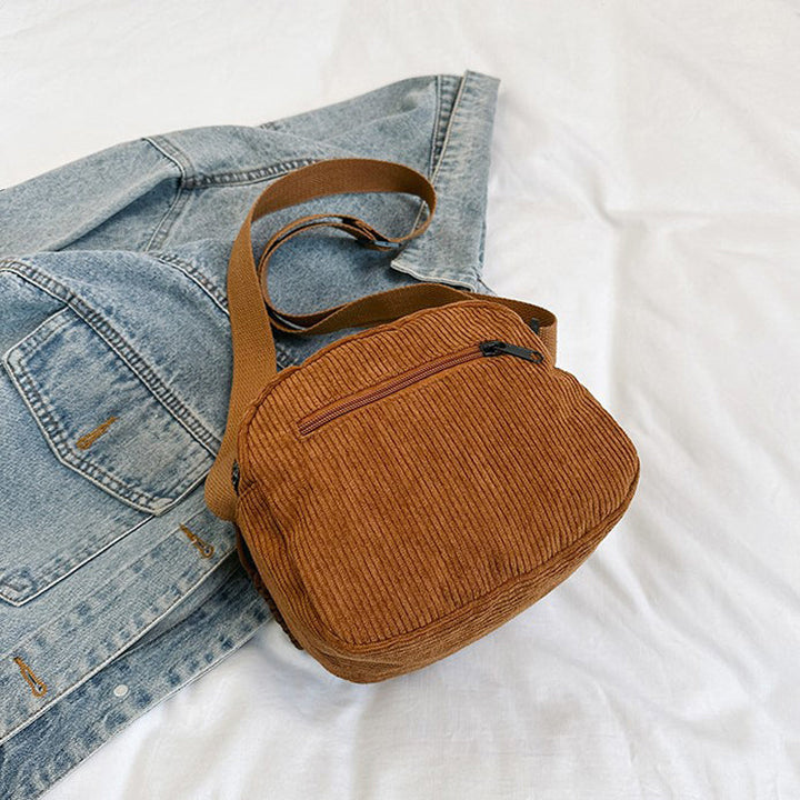 Elegant small crossbody bag with a convenient zip closure for women.