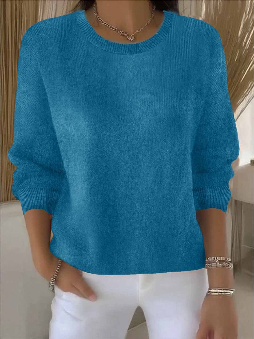 Close-up of the soft knit fabric on a women's V-neck sweater, highlighting comfort.
