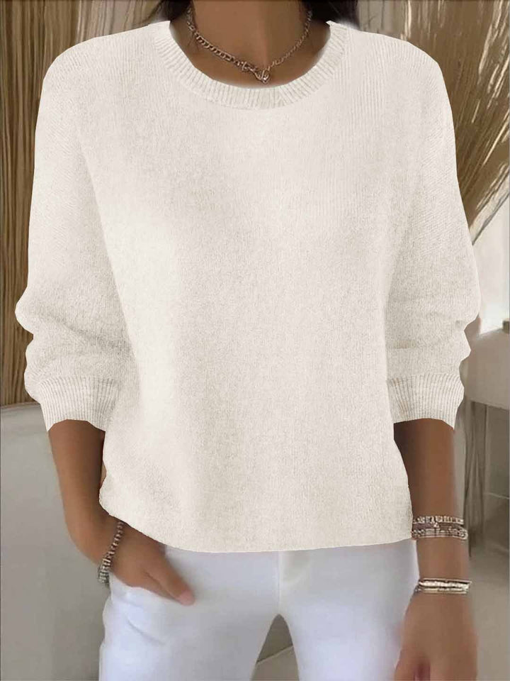 Versatile women's V-neck sweater shown in a cream color, suitable for any occasion.