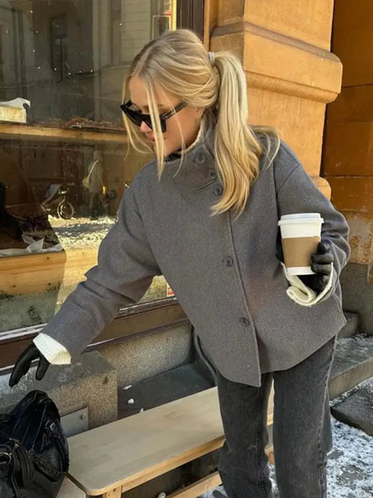 Close-up of the stand collar on a women's elegant pea coat, highlighting quality tailoring.
