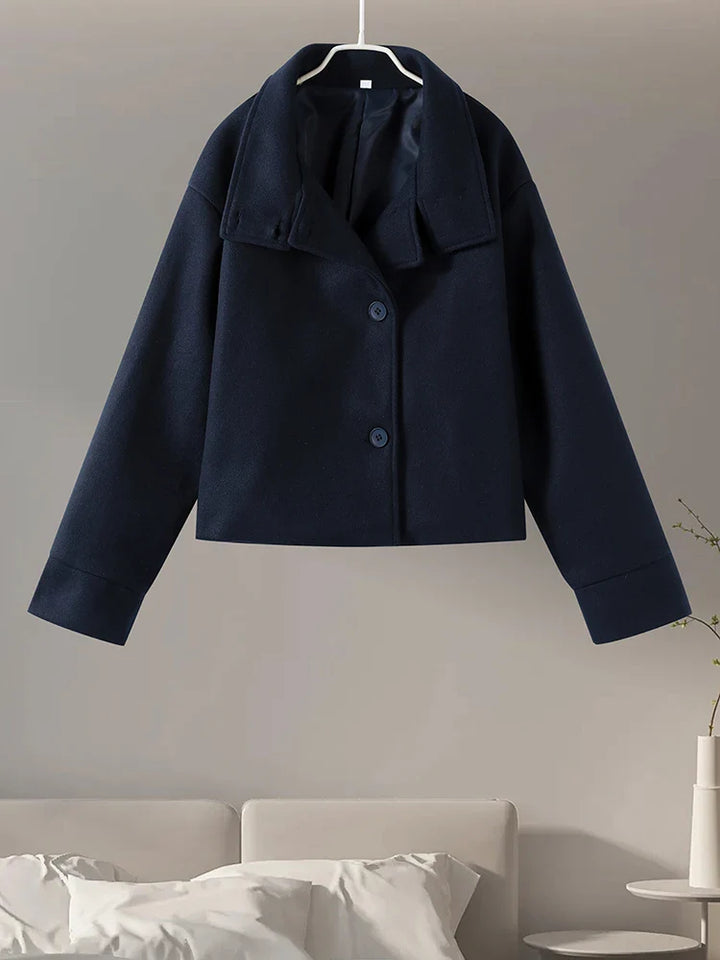 Minimalist fashion winter coat for women, featuring a sharp stand collar detail.