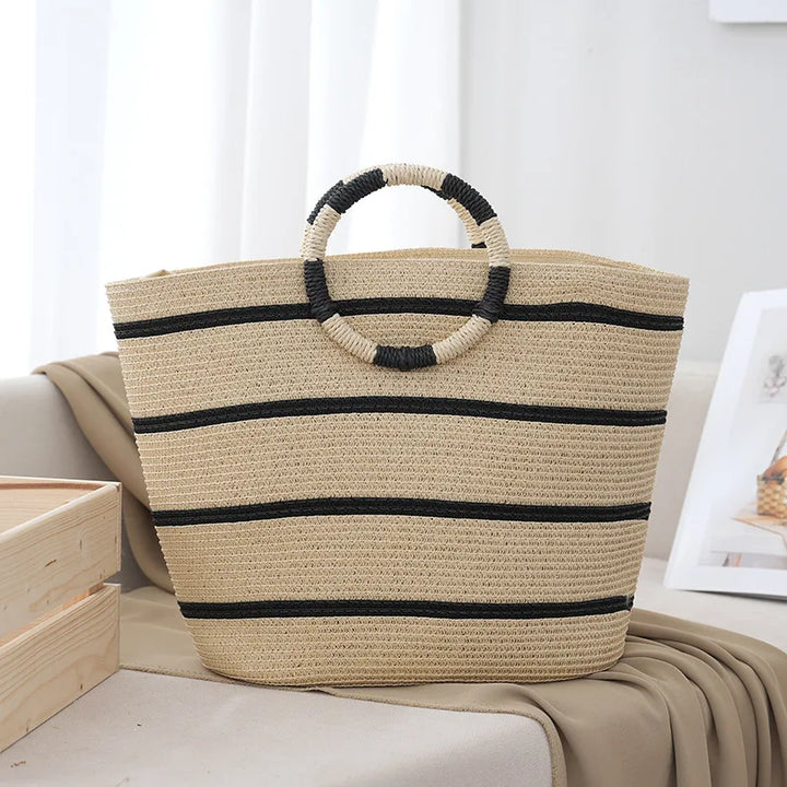 Women's striped beach tote bag with natural woven handles, perfect for summer outings and everyday use.