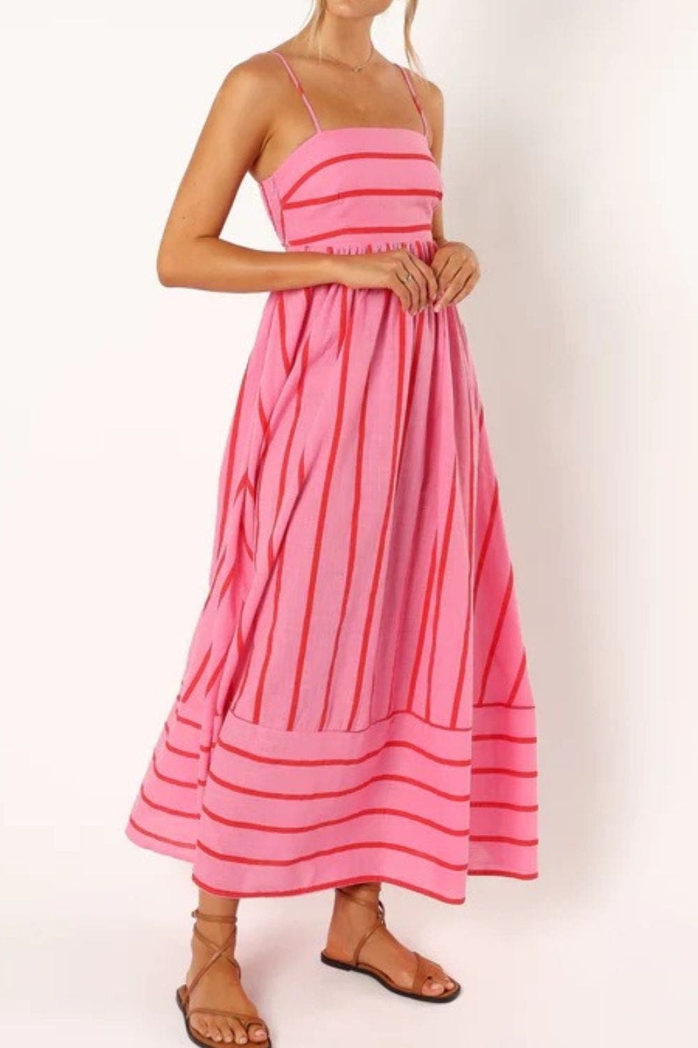 Chic striped maxi dress with thin straps, perfect for beach or casual summer outings.