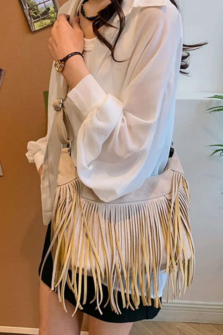 Compact women's suede fringe bag, perfect for festivals and travel.