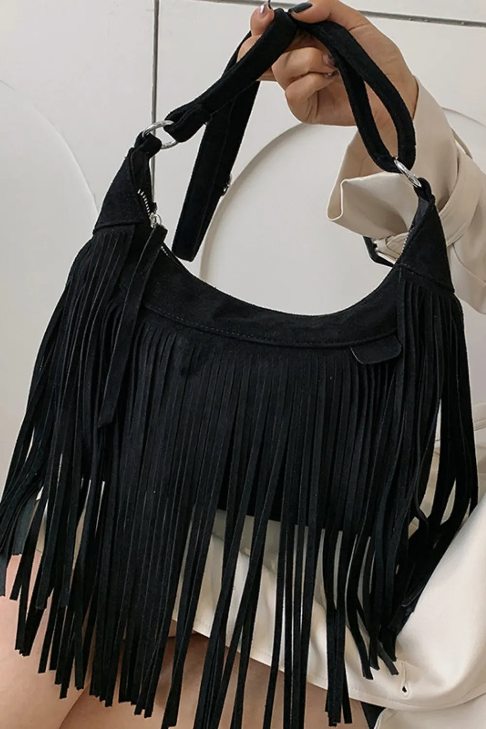 Natural tan suede fringe bag with rustic western appeal.