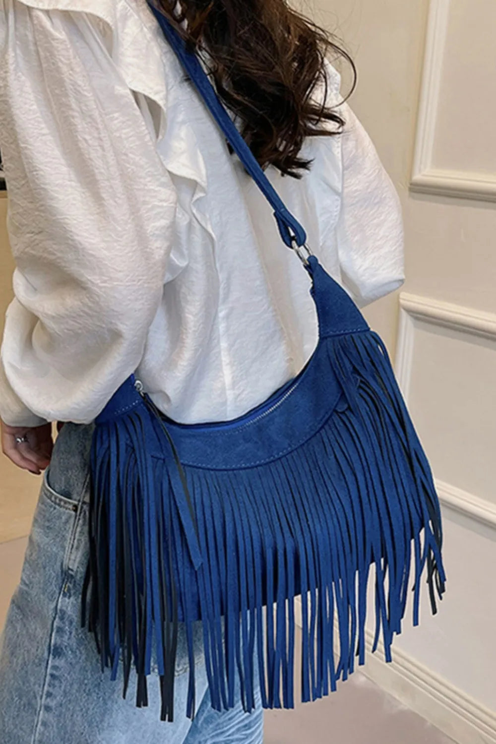 Elegant women's fringe shoulder bag, blending boho and modern style.