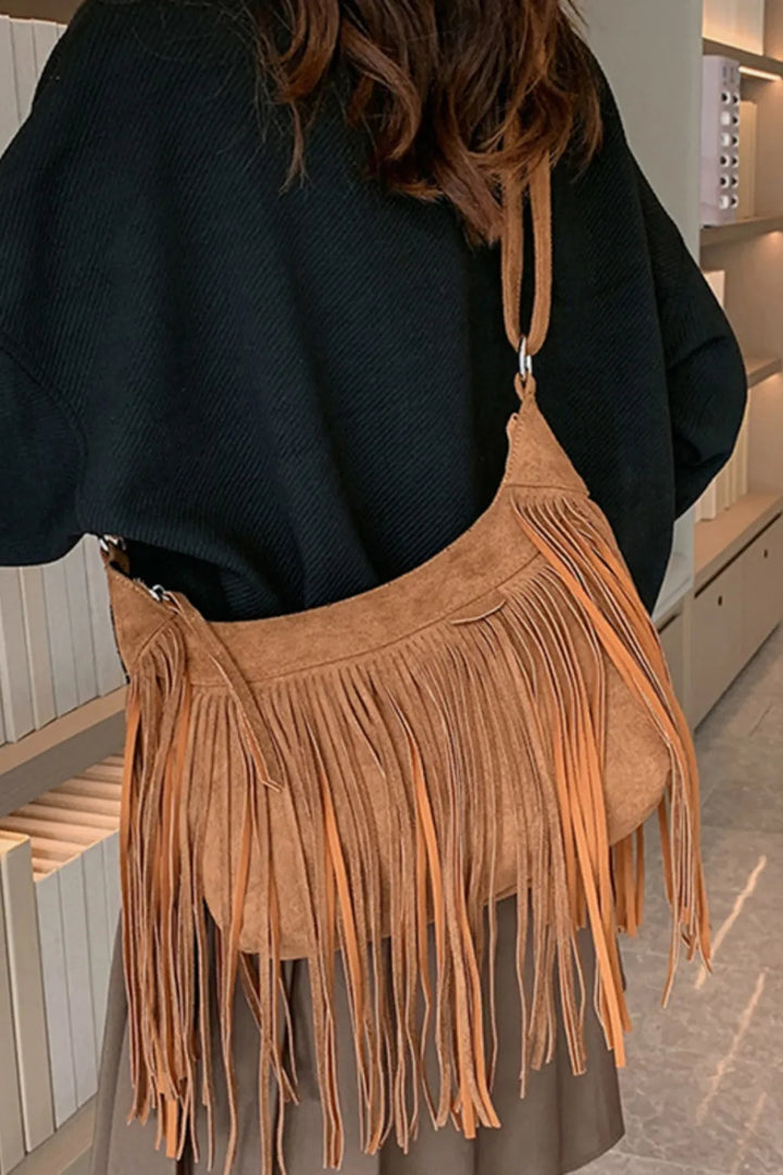 Brown suede crossbody bag with long fringe, perfect for western style.