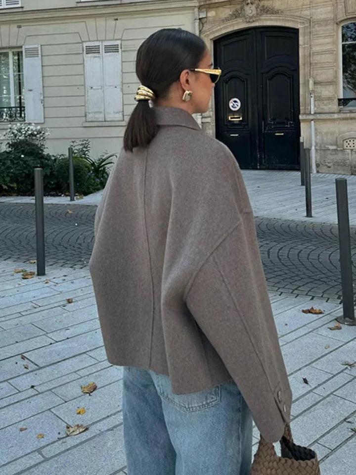 Close-up of the texture on a women's cream cropped wool blend jacket.