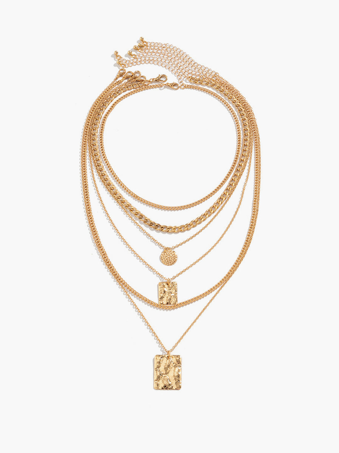 Close-up of a chic women's layered necklace showcasing textured gold pendants & delicate chains. Statement jewelry.