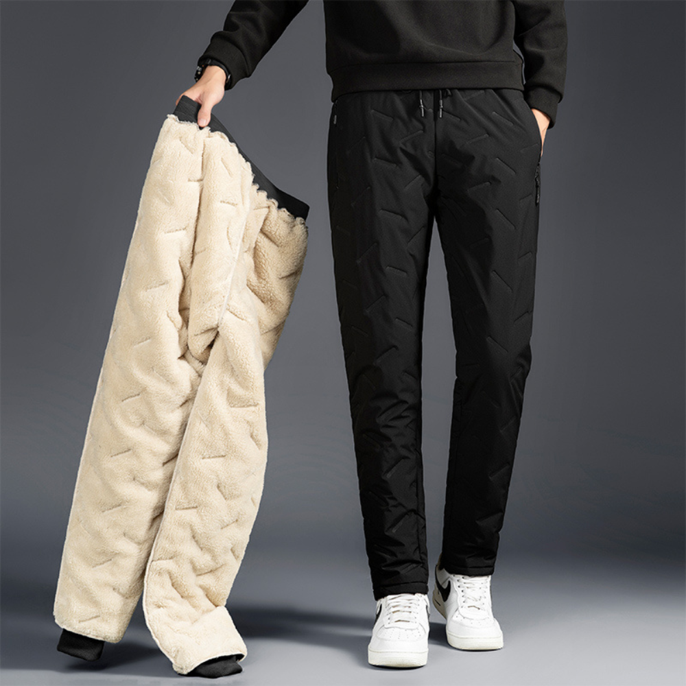Active woman hiking in durable thermal waterproof trousers. Ideal women's winter wear for cold weather & outdoor adventure.