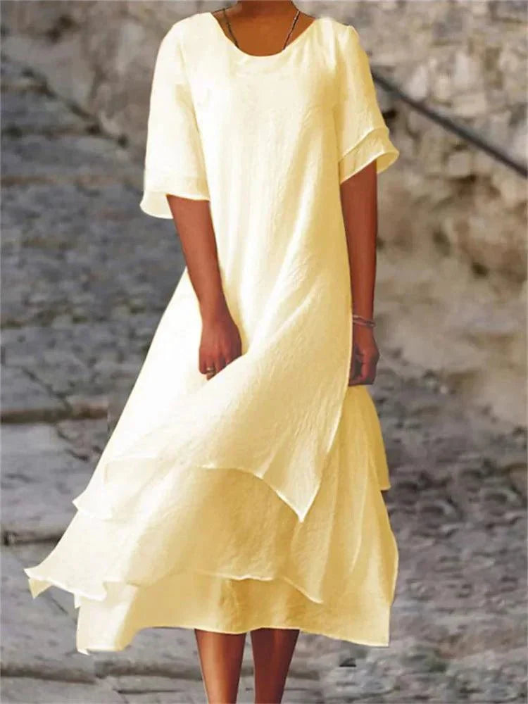 Elegant women's A-line tiered midi dress. Flattering short sleeve design, ideal for casual summer or spring occasions.
