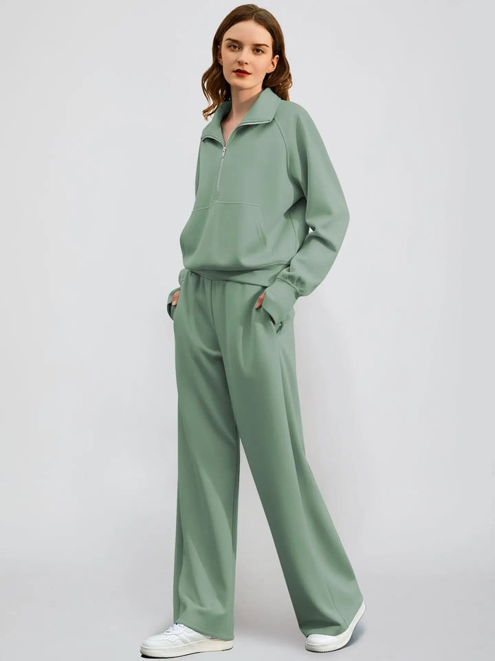 Women's two-piece leisure set featuring a half zip sweatshirt and wide-leg pants in a solid color.