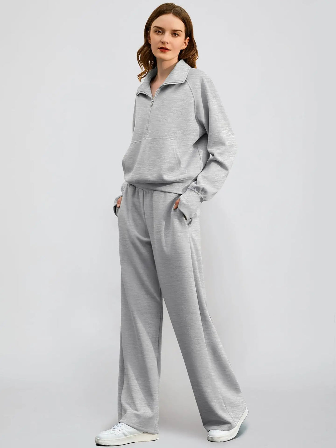 Modern women's two-piece ensemble: sporty half zip sweatshirt and elegant wide-leg trousers.
