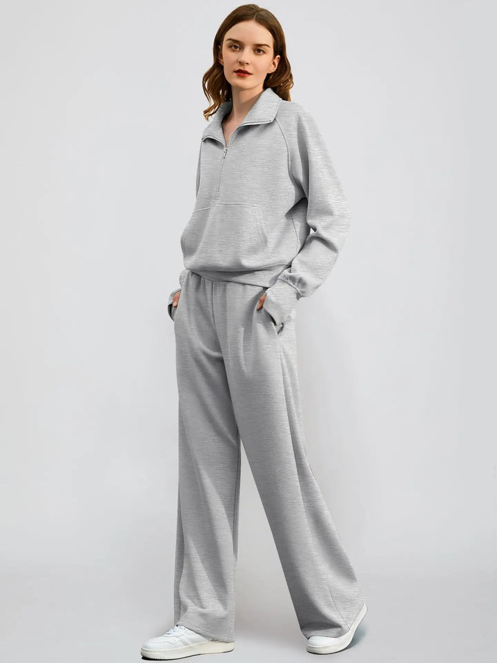 Modern women's two-piece ensemble: sporty half zip sweatshirt and elegant wide-leg trousers.