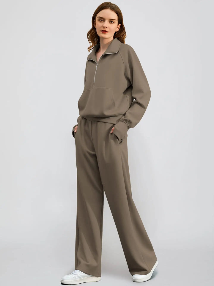Solid color women's athleisure set: casual half zip sweatshirt paired with trendy wide-leg trousers.