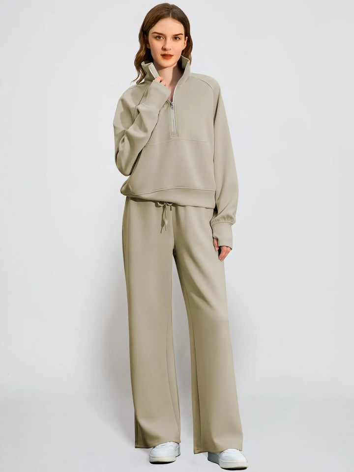 Complete casual outfit for women: half zip hooded sweatshirt and coordinating wide-leg pants.