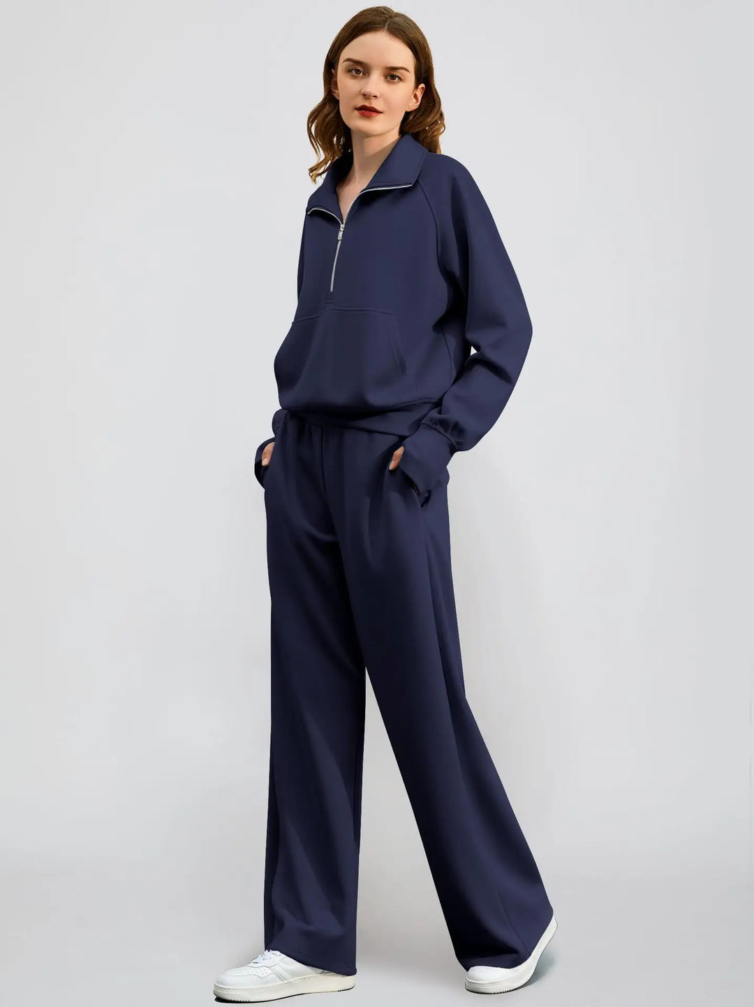 Stylish women's leisurewear set: ribbed knit half zip sweatshirt and flowing wide-leg pants.