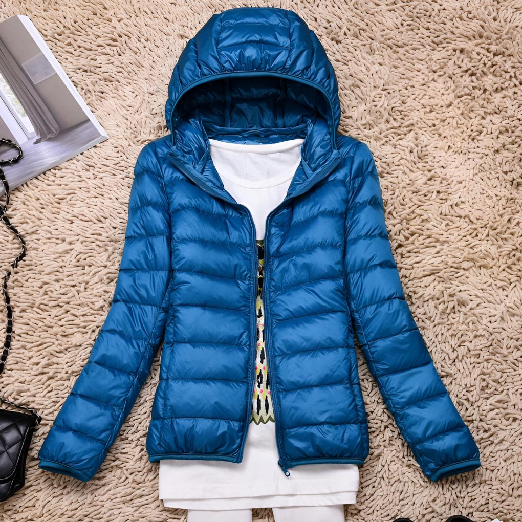 Cozy women's insulated hooded jacket. Ultra-light, packable design for winter outdoor gear & versatile travel.