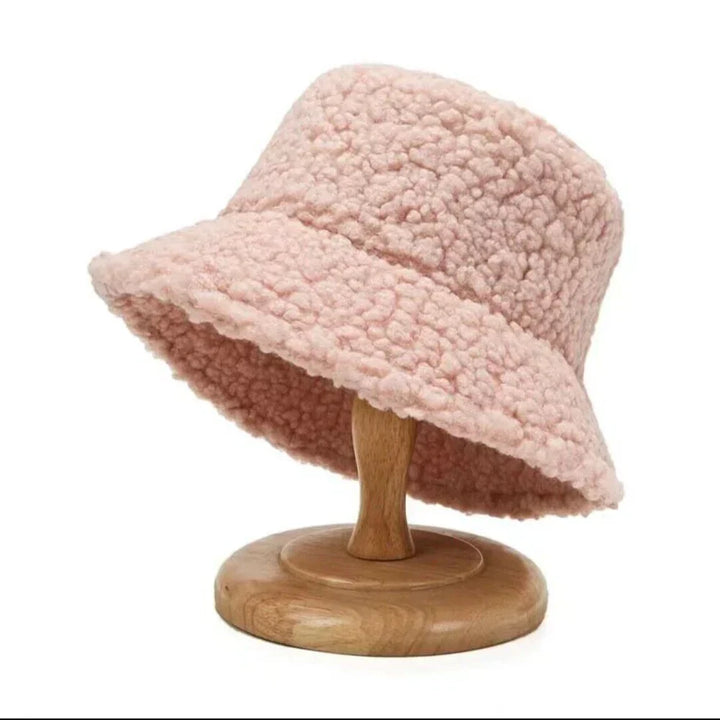 Versatile women's warm bucket hat in soft teddy material, a fashionable and cozy accessory for winter style.