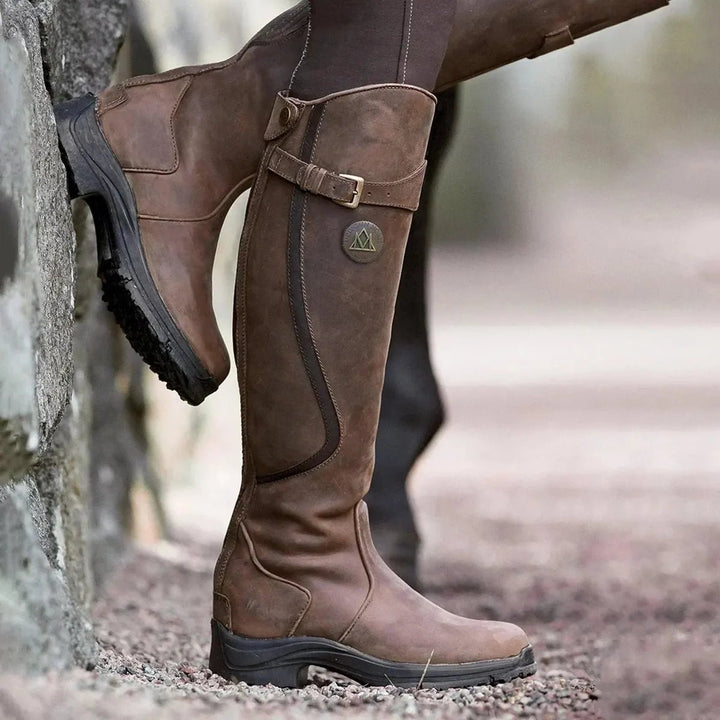 Women's waterproof leather riding boots in black, stylish and durable footwear for outdoor adventures.
