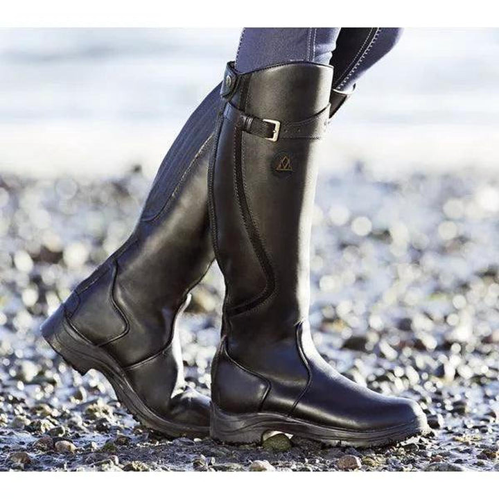 Side view of women's waterproof riding boots, highlighting the durable leather and practical heel.