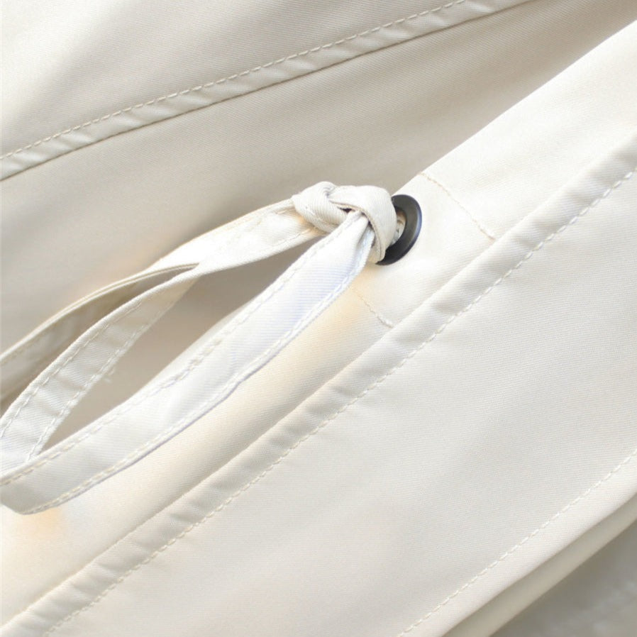Close-up of women's rain jacket fabric, showing its durable waterproof material.