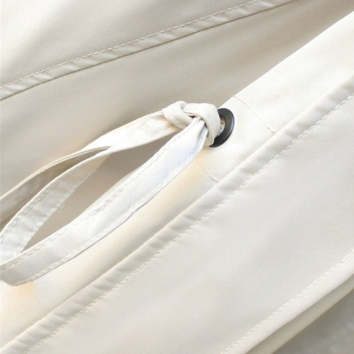 Close-up of women's rain jacket fabric, showing its durable waterproof material.