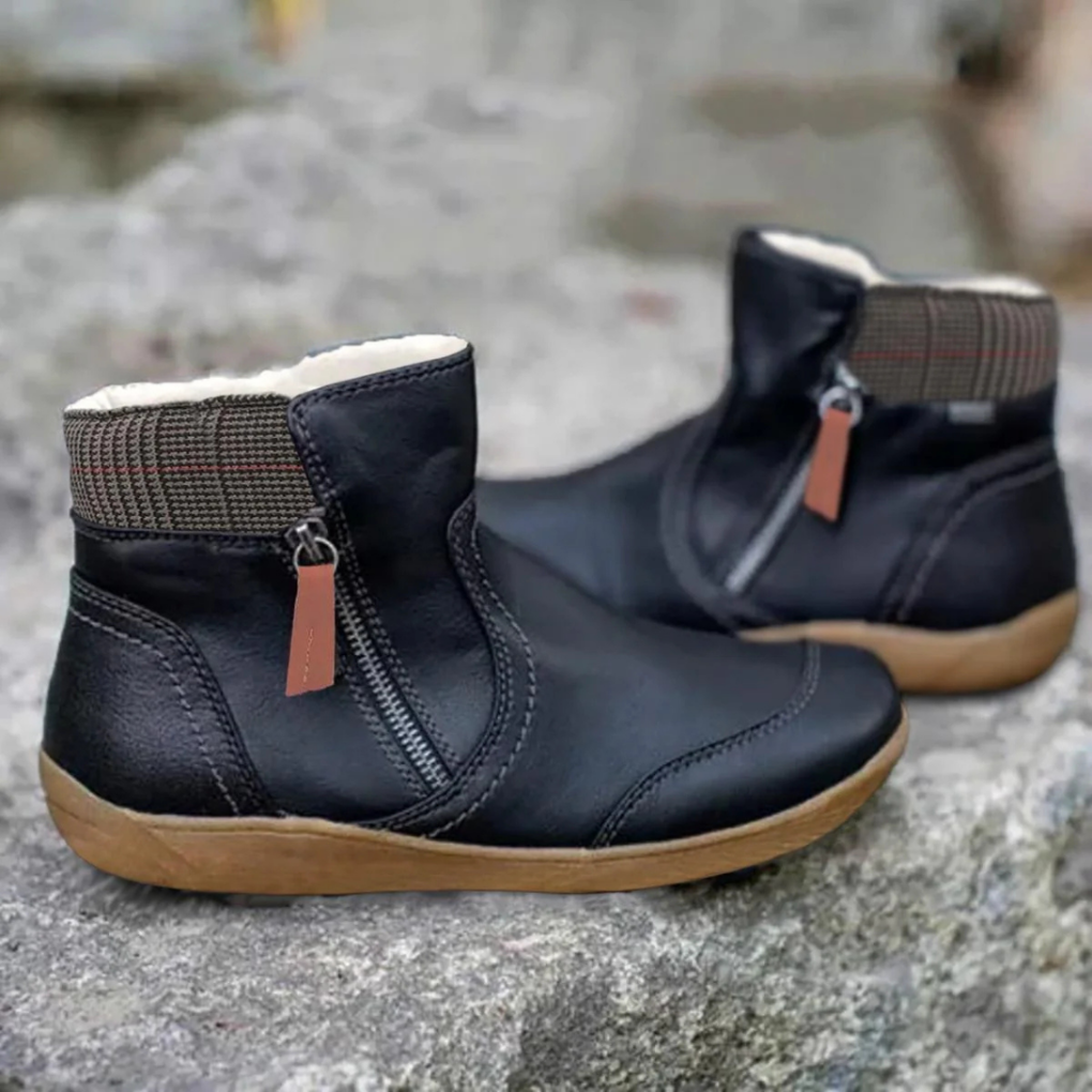 Close-up of women's lace-up snow boots, highlighting water-resistant material.