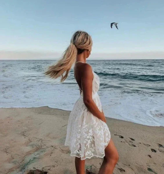 Elegant women's white halter neck mini summer dress, a versatile choice for beach parties or special events.