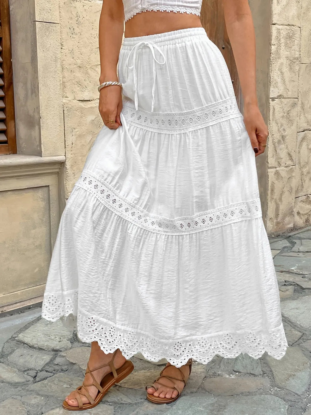 Elegant white lace maxi skirt, perfect for casual or beach wear, featuring a feminine flowy design.