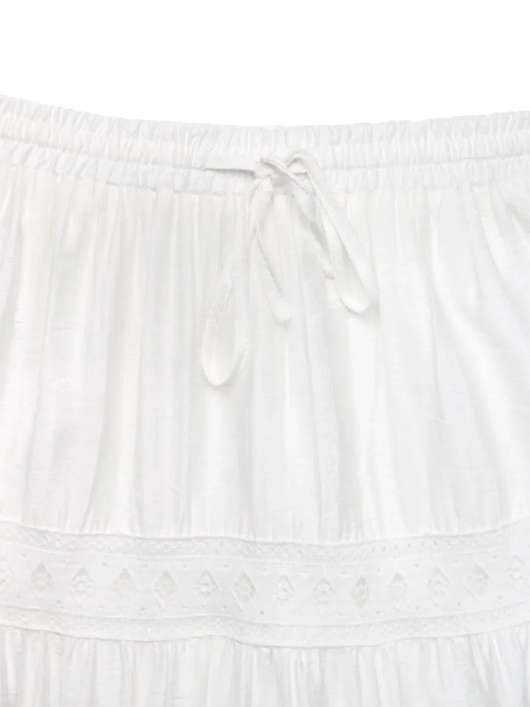White lace maxi skirt with a relaxed fit and tie waist, embodying effortless summer style.