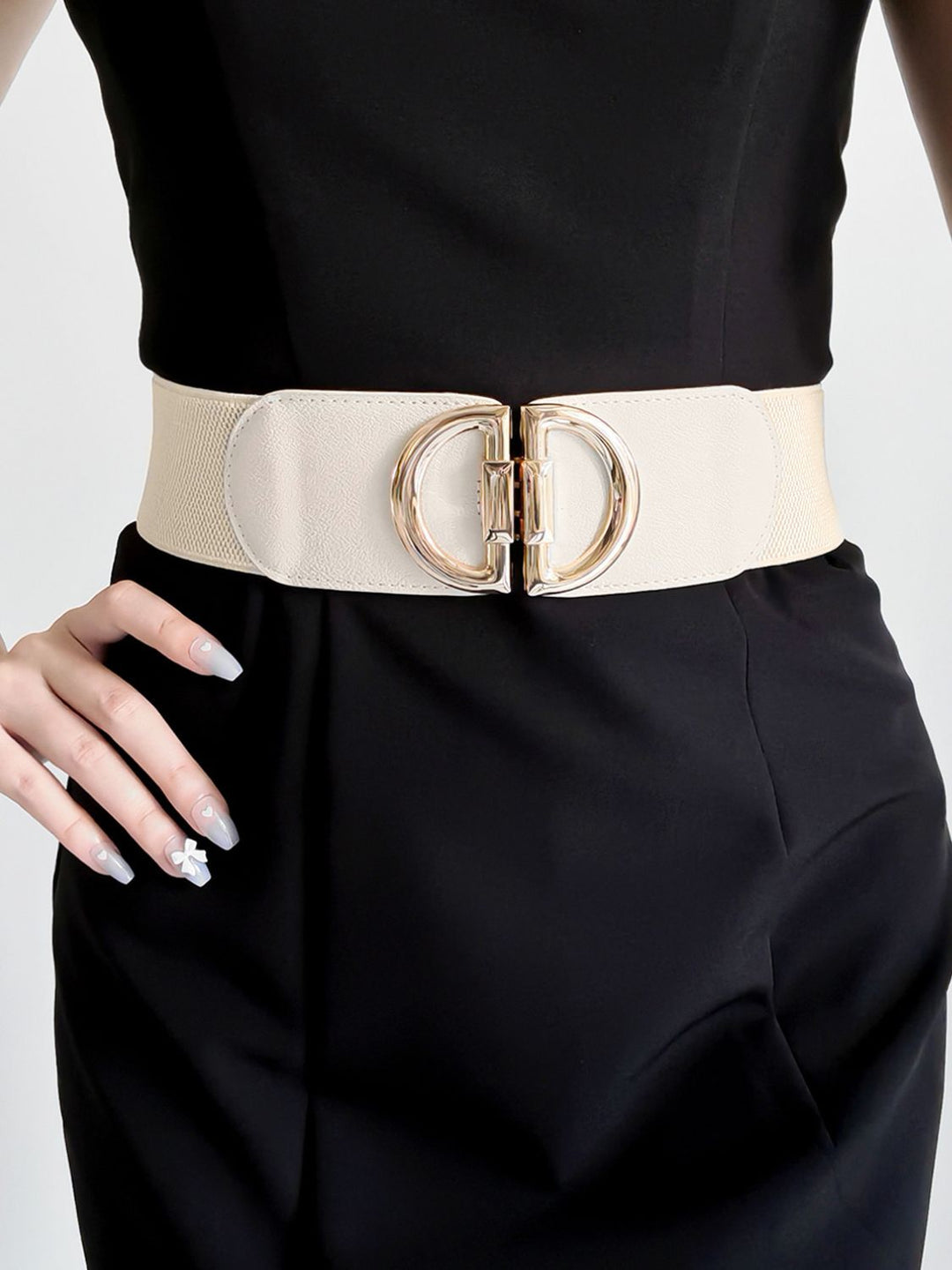 A must-have women's accessory: wide elastic belt with a chic gold buckle