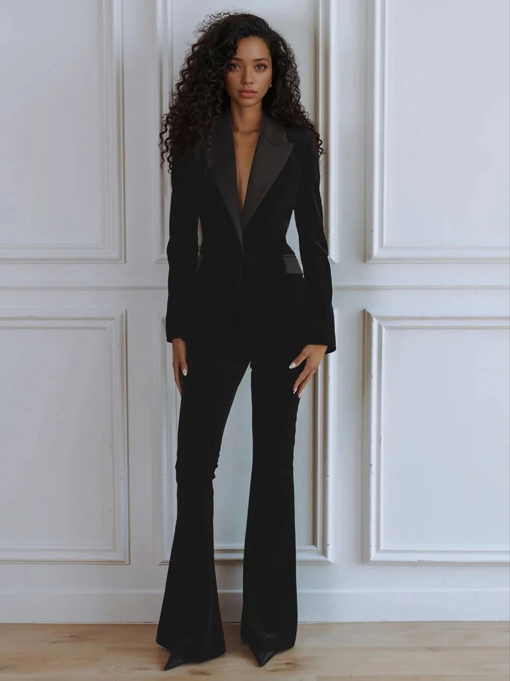Elegant women's two-piece suit with a blazer and flare trousers. Chic professional workwear.