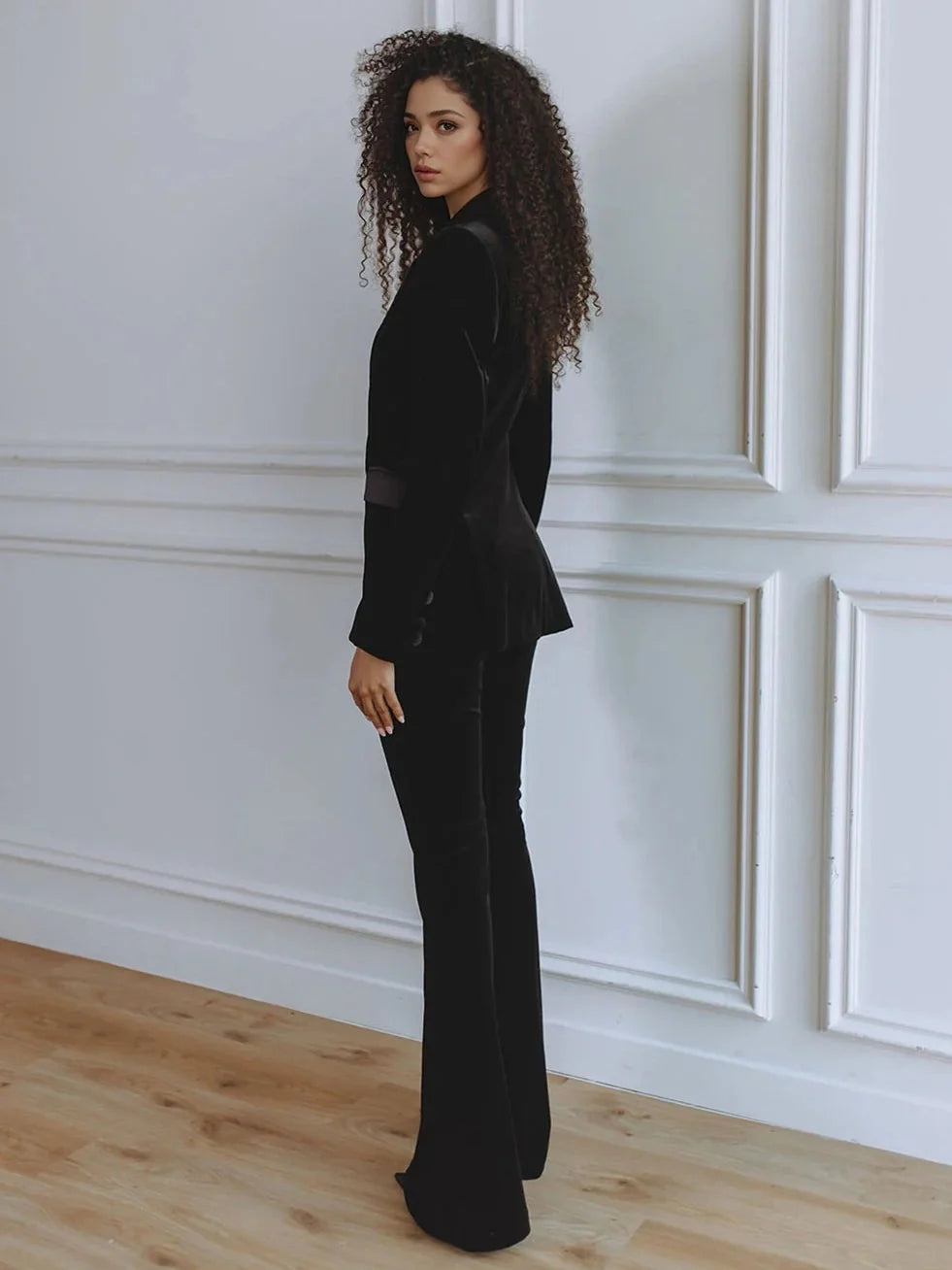 Modern women's co-ord blazer and flare trouser outfit. Fashionable office and business attire.